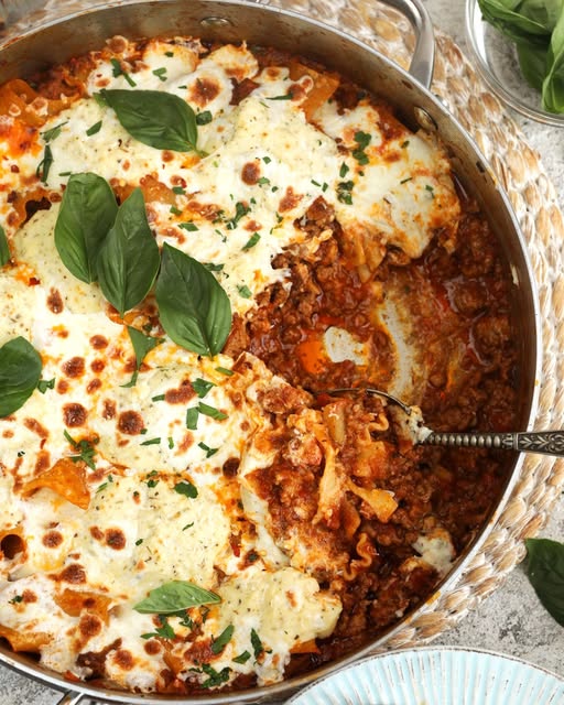 All the flavor of your favorite lasagna without all the work!  One pot Skillet Lasagna bakes up bubbly and cheesy with tender beef and pasta. So easy!